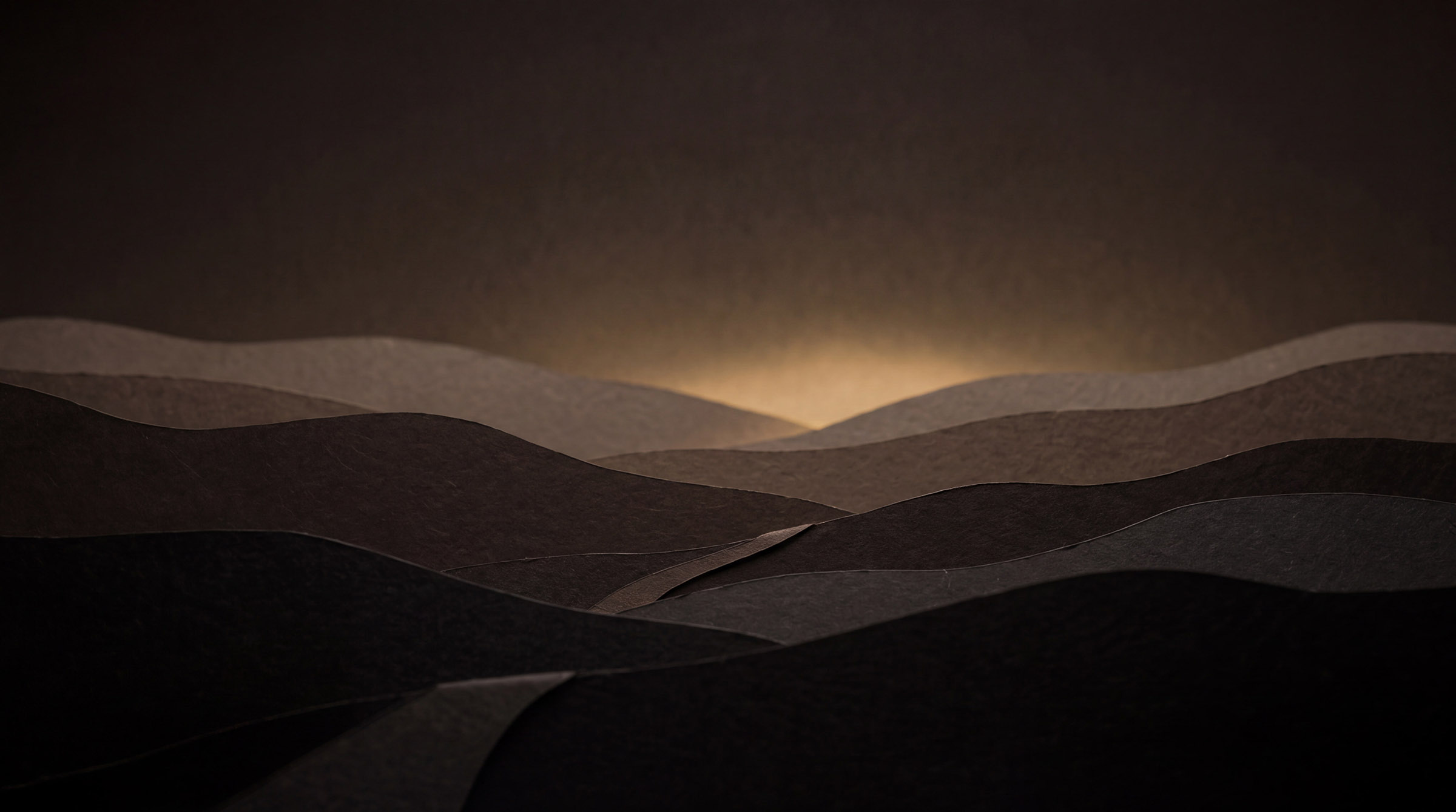 A still lake beneath soft hills at first light